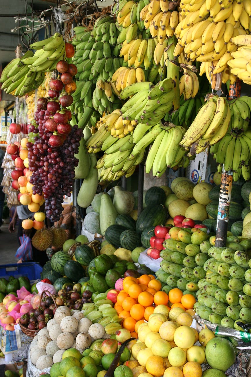 abundance of a variety of fruit arranged in orderly fashion scaling up the produce stand